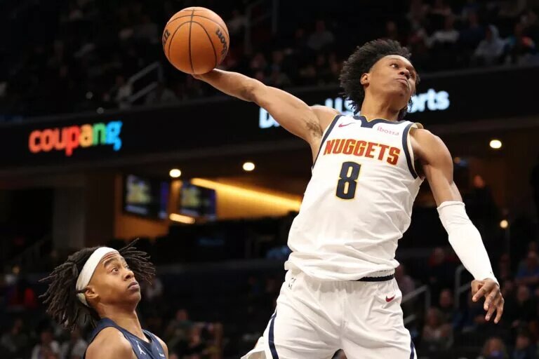 Jan 22, 2026; Washington, District of Columbia, USA; Denver Nuggets guard Peyton Watson (8) attempts a dunk over Washington Wizards guard Tre Johnson (12) during the second half at Capital One Arena. Mandatory Credit: Daniel Kucin Jr.-Imagn Images
