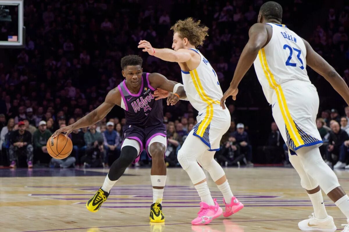 Minnesota Timberwolves star Anthony Edwards guarded by Golden State Warriors guard Brandin Podziemski and forward Draymond Green