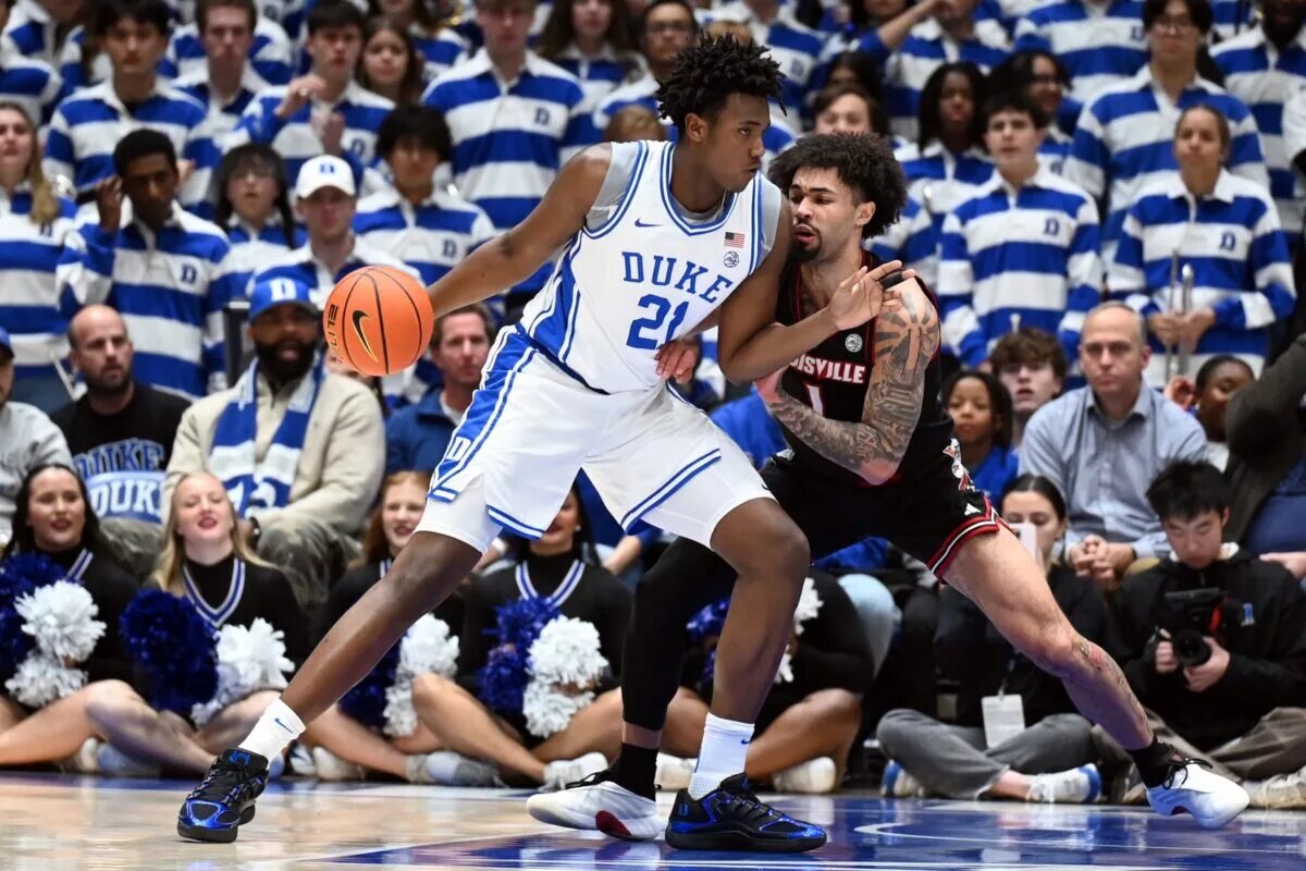 Duke Blue Devils center Patrick Ngongba II (21) drives to the basket as Louisville Cardinals guard J'Vonne Hadley (1) defends during the first half at Cameron Indoor Stadium.
