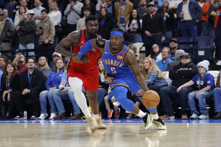 Jan 27, 2026; Oklahoma City, Oklahoma, USA; Oklahoma City Thunder guard Luguentz Dort (5) drives to the basket around New Orleans Pelicans forward Zion Williamson (1) during the second half at Paycom Center. Mandatory Credit: Alonzo Adams-Imagn Images