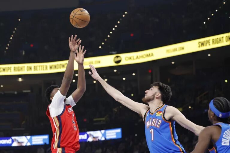 Jan 27, 2026; Oklahoma City, Oklahoma, USA; New Orleans Pelicans center Derik Queen (22) shoots over Oklahoma City Thunder center/forward Chet Holmgren (7) during the second quarter at Paycom Center. Mandatory Credit: Alonzo Adams-Imagn Images