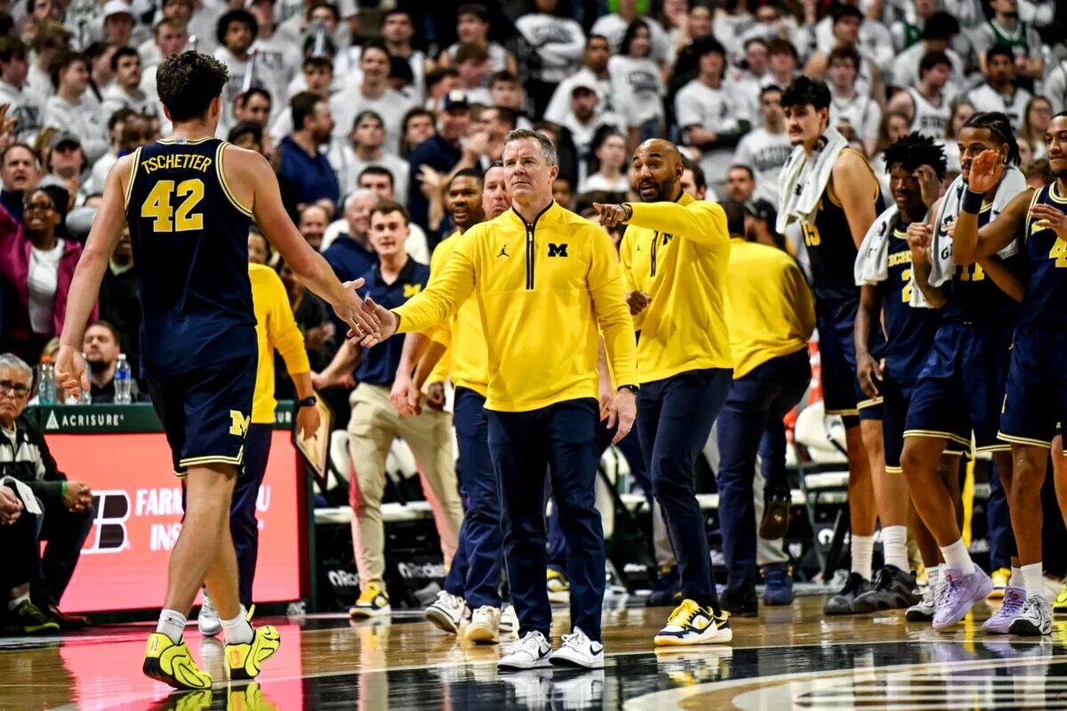 Dusty May and Will Tschetter bumps hands during the Wolverines game at Michigan State