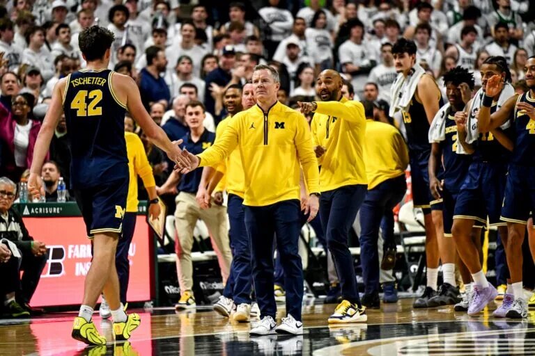 Dusty May and Will Tschetter bumps hands during the Wolverines game at Michigan State