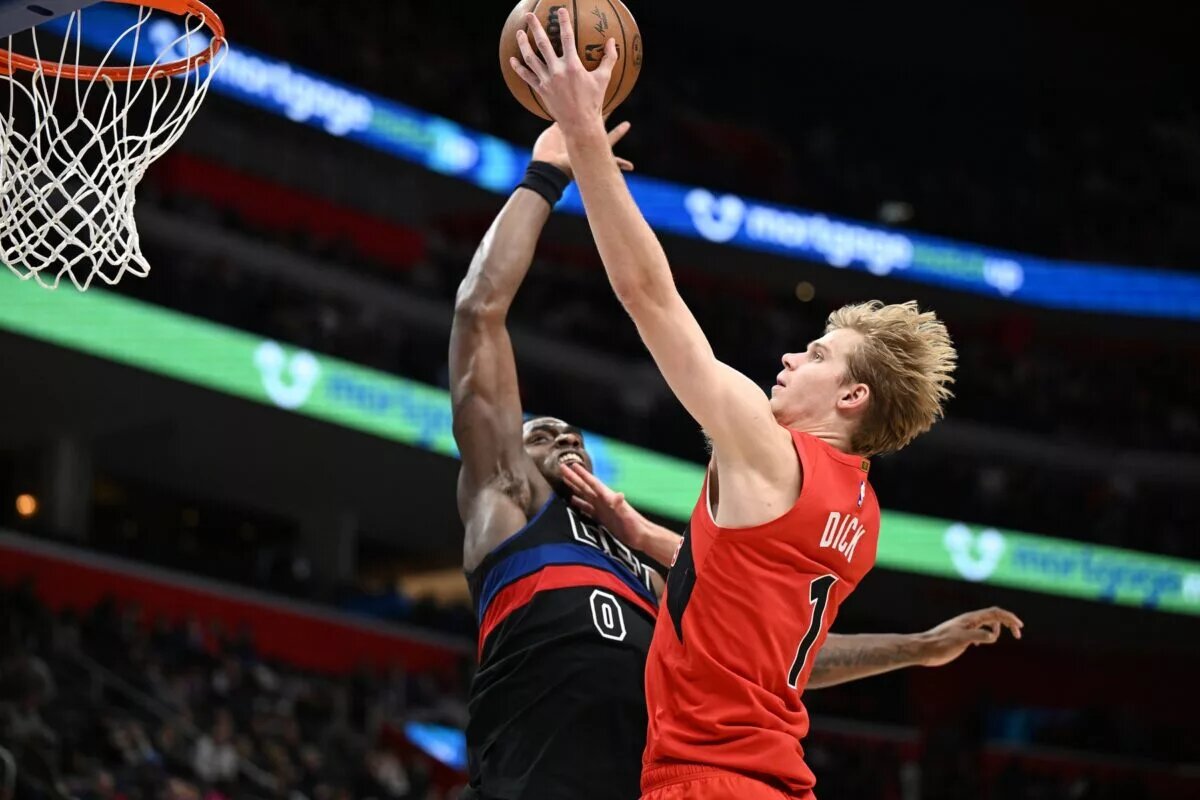 Jan 11, 2025; Detroit, Michigan, USA; Toronto Raptors guard Gradey Dick (1) has his shot blocked by Detroit Pistons center Jalen Duren (0) in the third quarter at Little Caesars Arena. Mandatory Credit: Lon Horwedel-Imagn Images