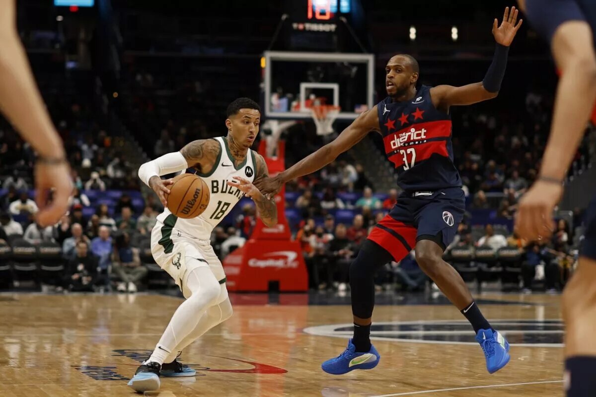 Feb 21, 2025; Washington, District of Columbia, USA; Milwaukee Bucks forward Kyle Kuzma (18) drives to the basket as Washington Wizards forward Khris Middleton (32) defends in the first half at Capital One Arena. Mandatory Credit: Geoff Burke-Imagn Images