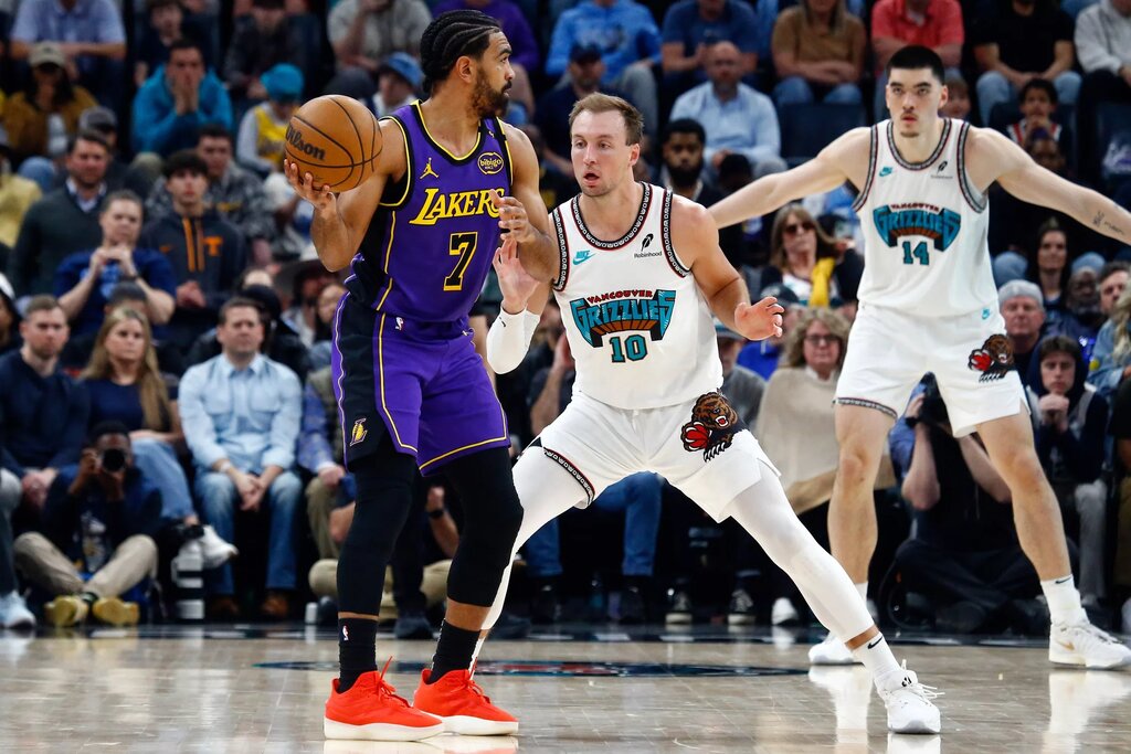 Mar 29, 2025; Memphis, Tennessee, USA; Los Angeles Lakers guard Gabe Vincent (7) handles the ball as Memphis Grizzlies guard Luke Kennard (10) defends during the fourth quarter at FedExForum. Mandatory Credit: Petre Thomas-Imagn Images