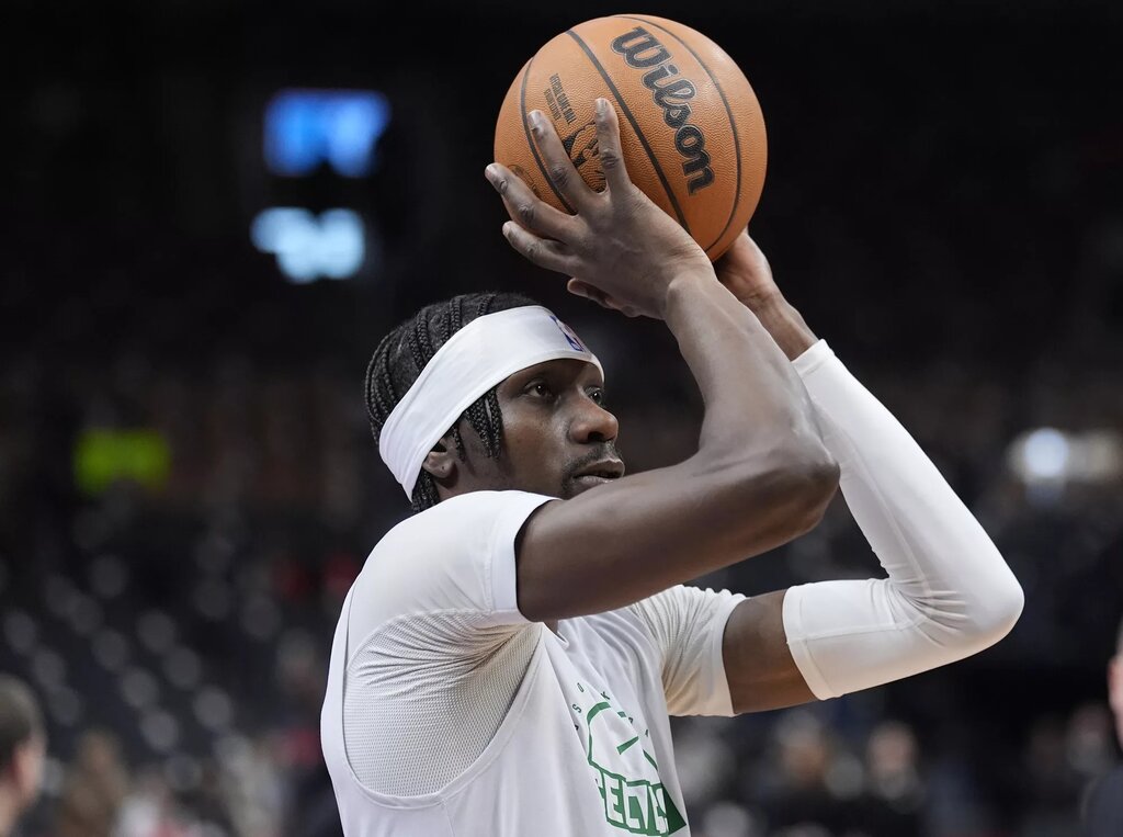 Boston Celtics center Chris Boucher (99) goes to shoot a basket during warm up before a game against the Toronto Raptors at Scotiabank Arena.