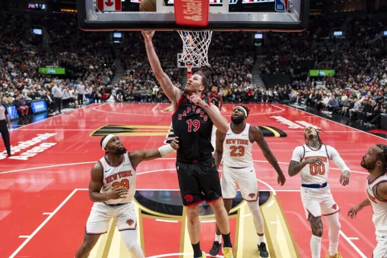 Dec 9, 2025; Toronto, Ontario, CAN; Toronto Raptors center Jakob Poeltl (19) drives to the basket during the first half against the New York Knicks at the 2025-26 NBA Emirates Cup at Scotiabank Arena. Mandatory Credit: Kevin Sousa-Imagn Images