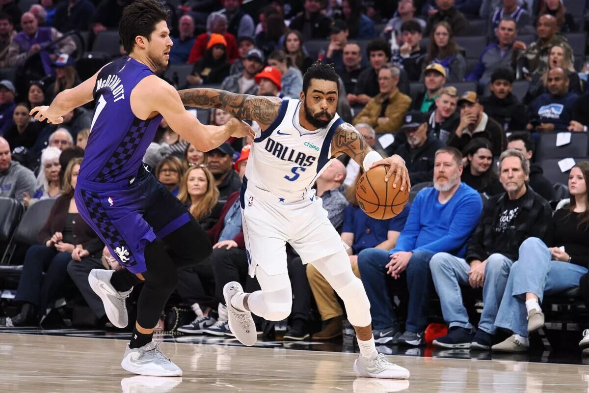 Dallas Mavericks guard D'Angelo Russell (5) controls the ball against Sacramento Kings forward Doug McDermott (7) during the second quarter at Golden 1 Center.