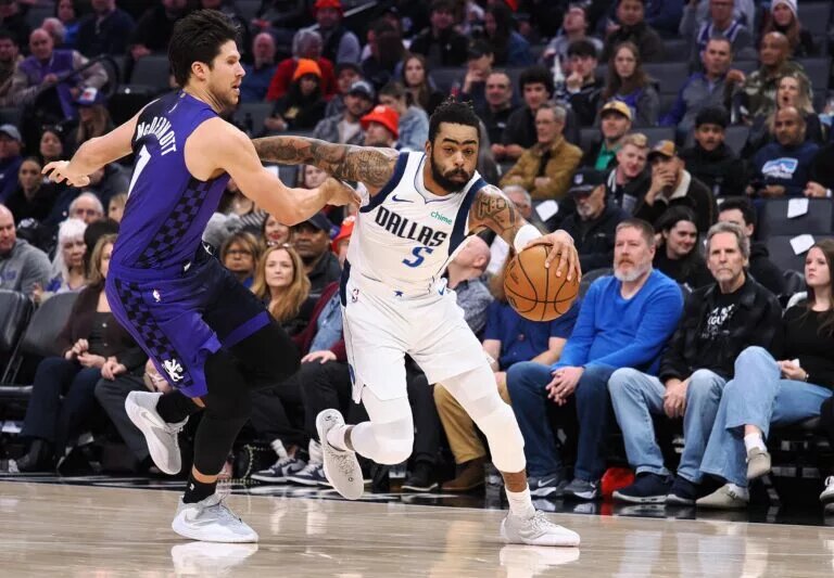 Dallas Mavericks guard D'Angelo Russell (5) controls the ball against Sacramento Kings forward Doug McDermott (7) during the second quarter at Golden 1 Center.