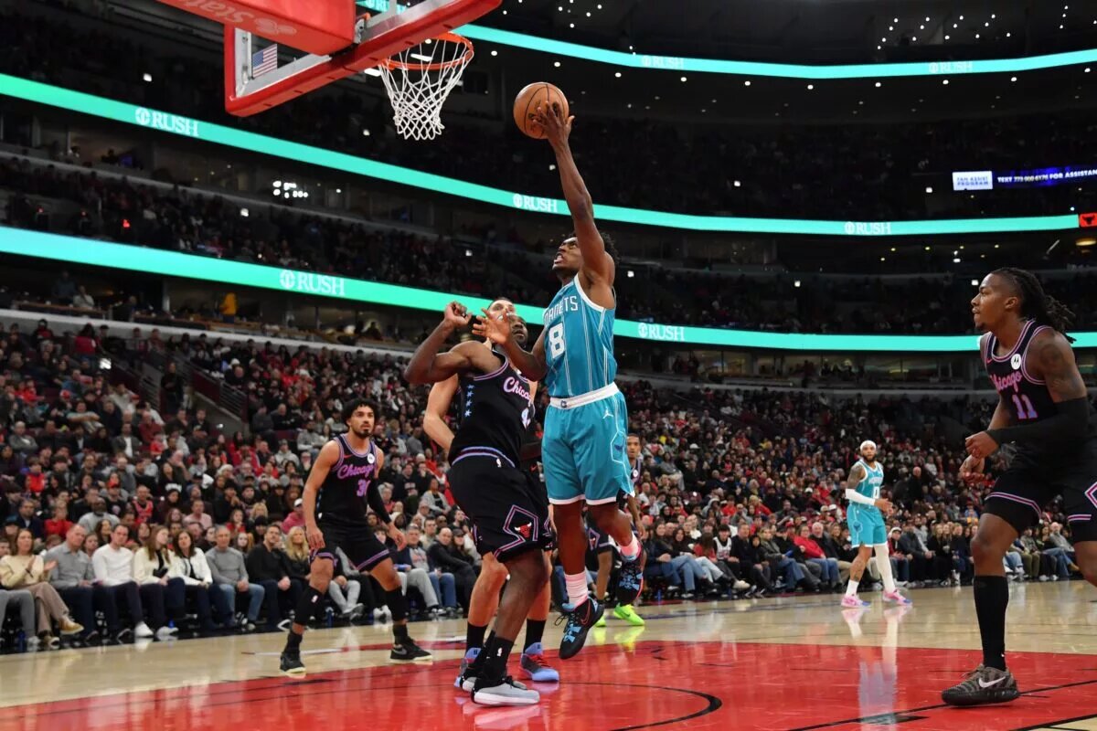 Charlotte Hornets guard Collin Sexton scores on a layup while playing the Chicago Bulls