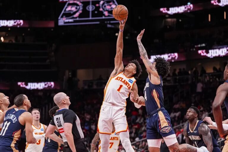 Jan 7, 2026; Atlanta, Georgia, USA; Atlanta Hawks forward Jalen Johnson (1) wins a jump ball against New Orleans Pelicans guard Micah Peavy (14) during the second half at State Farm Arena. Mandatory Credit: Dale Zanine-Imagn Images