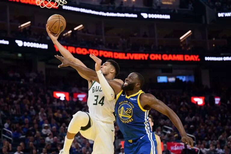 Jan 7, 2026; San Francisco, California, USA; Milwaukee Bucks forward Giannis Antetokounmpo (34) shoots the ball against Golden State Warriors forward Draymond Green (23) during the second quarter at Chase Center. Mandatory Credit: Robert Edwards-Imagn Images