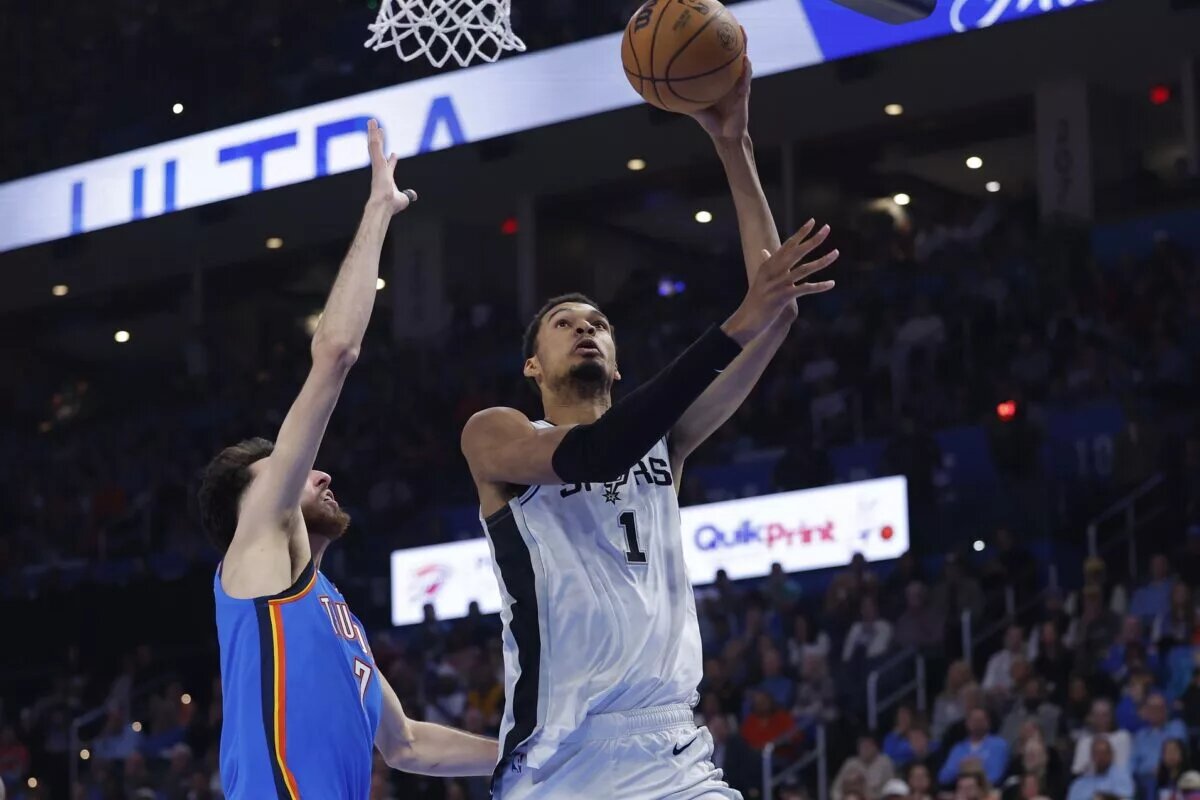 San Antonio Spurs forward/center Victor Wembanyama (1) goes up for a basket beside Oklahoma City Thunder center/forward Chet Holmgren (7) during the second quarter at Paycom Center.