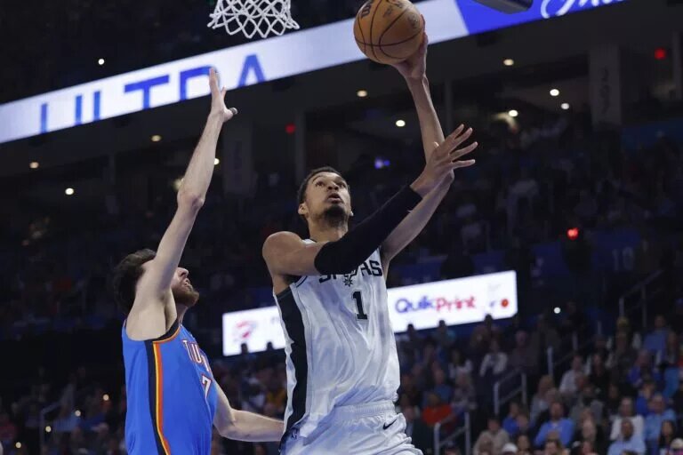 San Antonio Spurs forward/center Victor Wembanyama (1) goes up for a basket beside Oklahoma City Thunder center/forward Chet Holmgren (7) during the second quarter at Paycom Center.