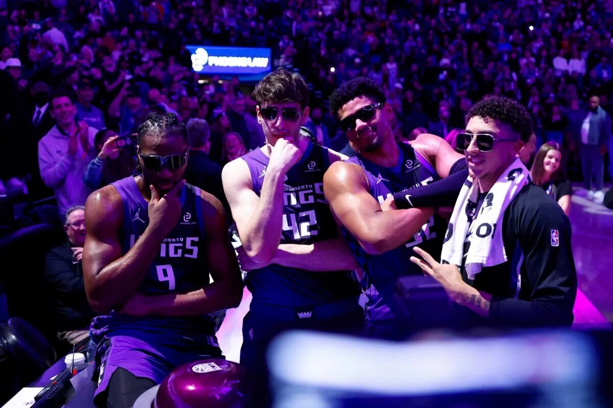 Sacramento Kings forward Precious Achiuwa (9) and center Maxime Raynaud (42) and center Dylan Cardwell (32) and guard Nique Clifford (5) celebrate after lighting the beam in celebration of their victory against the Washington Wizards