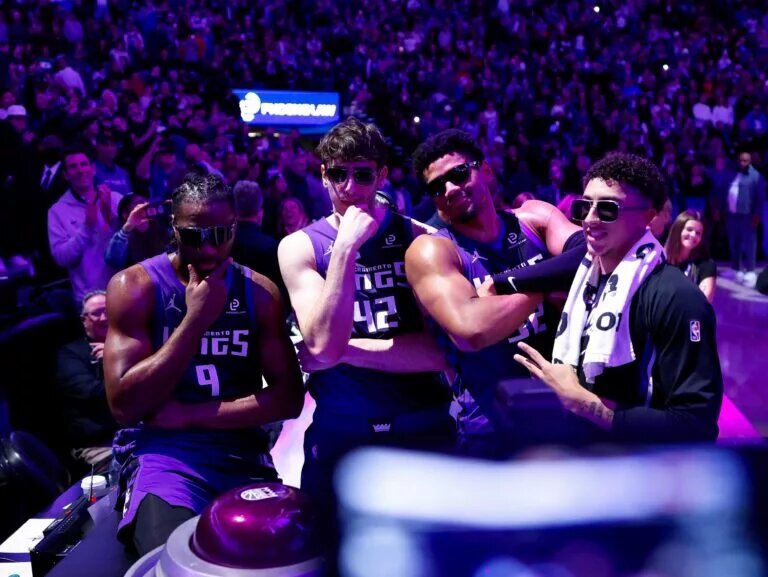 Sacramento Kings forward Precious Achiuwa (9) and center Maxime Raynaud (42) and center Dylan Cardwell (32) and guard Nique Clifford (5) celebrate after lighting the beam in celebration of their victory against the Washington Wizards