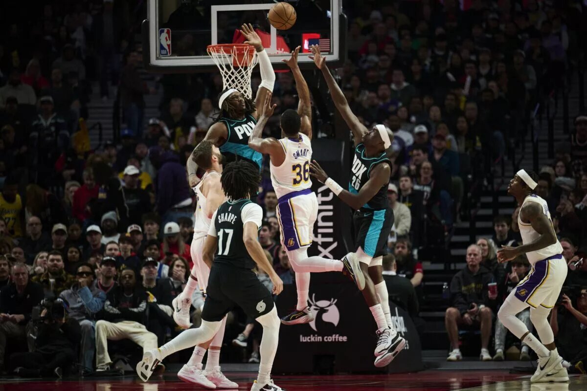 Jan 17, 2026; Portland, Oregon, USA; Los Angeles Lakers guard Marcus Smart (36) drives to the basket during the first half against Portland Trail Blazers center Robert Williams III (35) and center Duop Reath (26) at Moda Center. Mandatory Credit: Troy Wayrynen-Imagn Images
