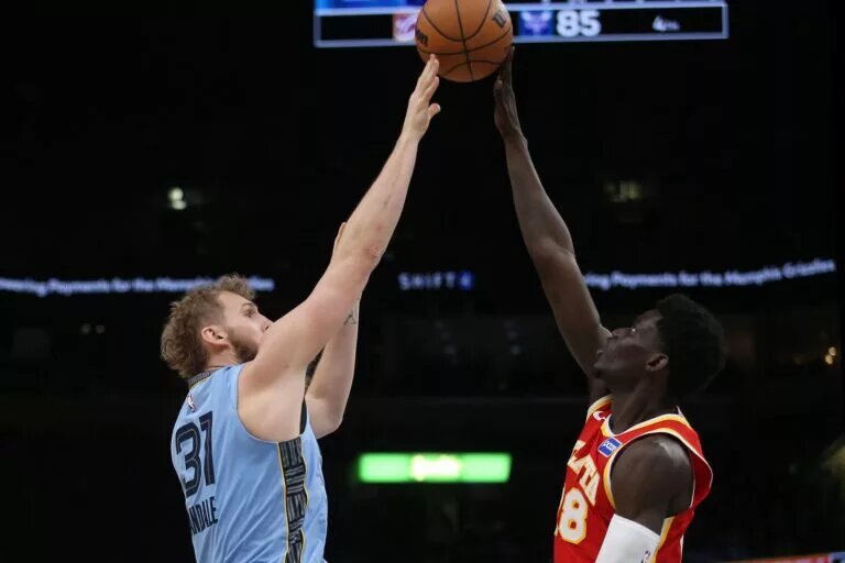 Jan 21, 2026; Memphis, Tennessee, USA; Atlanta Hawks forward Mouhamed Gueye (18) blocks a shot attempt by Memphis Grizzlies center Jock Landale (31) during the third quarter at FedExForum. Mandatory Credit: Petre Thomas-Imagn Images