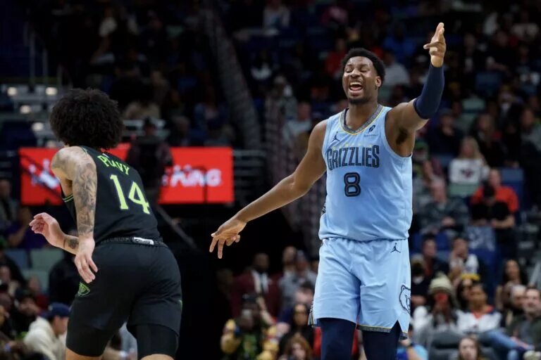 Memphis Grizzlies forward Jaren Jackson Jr. (8) reacts after a three point basket against New Orleans Pelicans guard Micah Peavy (14) during the first half at Smoothie King Center.