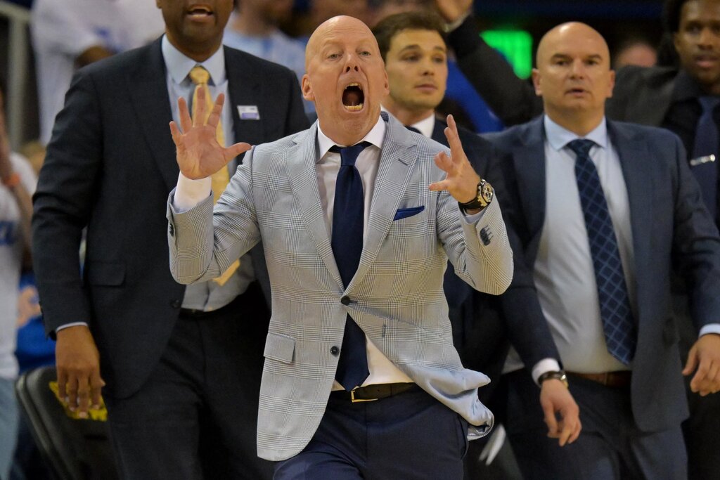 UCLA's Mick Cronin leads his team from the bench