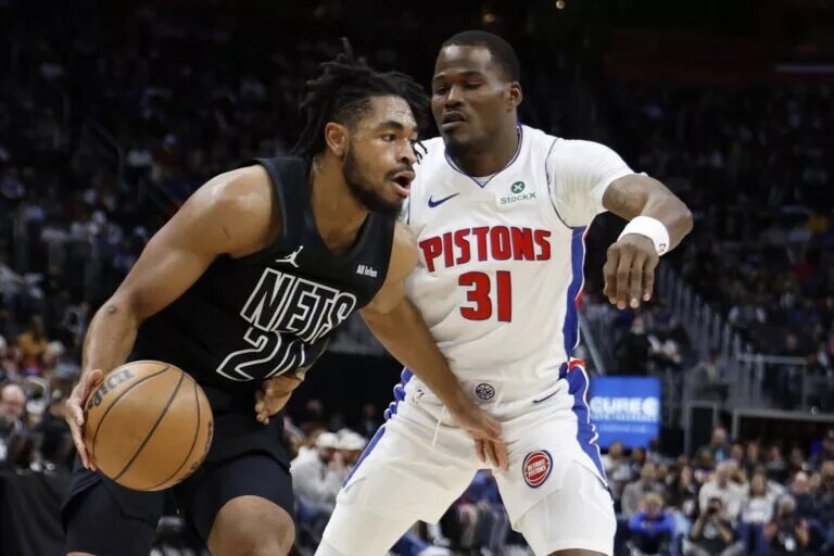 Brooklyn Nets guard Cam Thomas (24) dribbles on Detroit Pistons guard Javonte Green (31) in the first half at Little Caesars Arena.