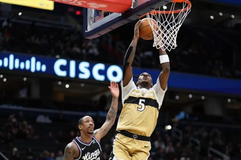 Feb 1, 2026; Washington, District of Columbia, USA; Washington Wizards guard Jamir Watkins (5) dunks over Sacramento Kings guard DeMar DeRozan (10) during the first half at Capital One Arena. Mandatory Credit: Daniel Kucin Jr.-Imagn Images