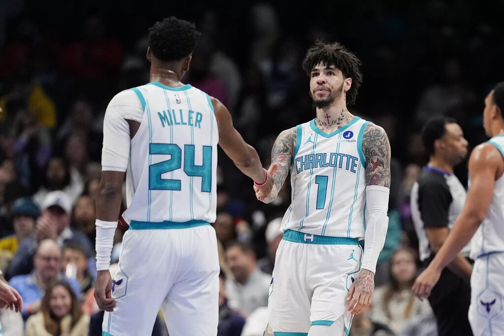 Feb 2, 2026; Charlotte, North Carolina, USA;Charlotte Hornets guard LaMelo Ball (1) and forward Brandon Miller (24) high five during the second quarter against the New Orleans Pelicans at the Spectrum Center. Mandatory Credit: Jim Dedmon-Imagn Images