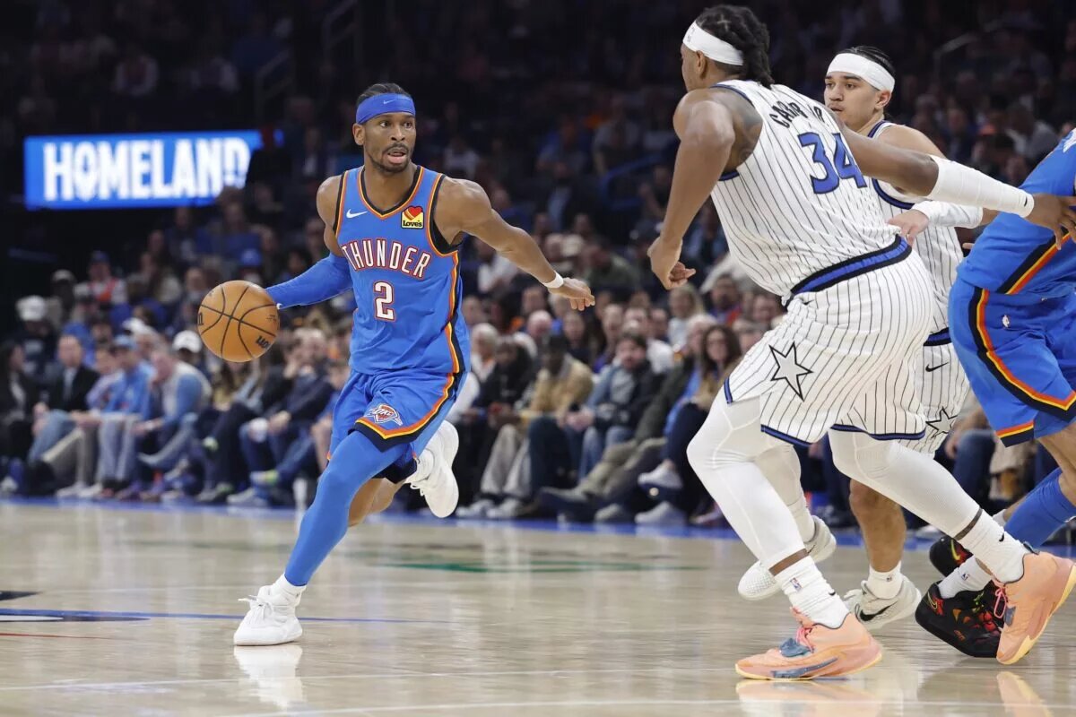 Oklahoma City Thunder guard Shai Gilgeous-Alexander (2) drives around Orlando Magic center/forward Wendell Carter Jr. (34) during the second half at Paycom Center.
