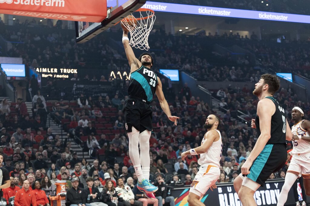 Portland Trail Blazers forward Toumani Camara (33) dunks the ball over Phoenix Suns guard/forward Dillon Brooks (3) during the first half at Moda Center.