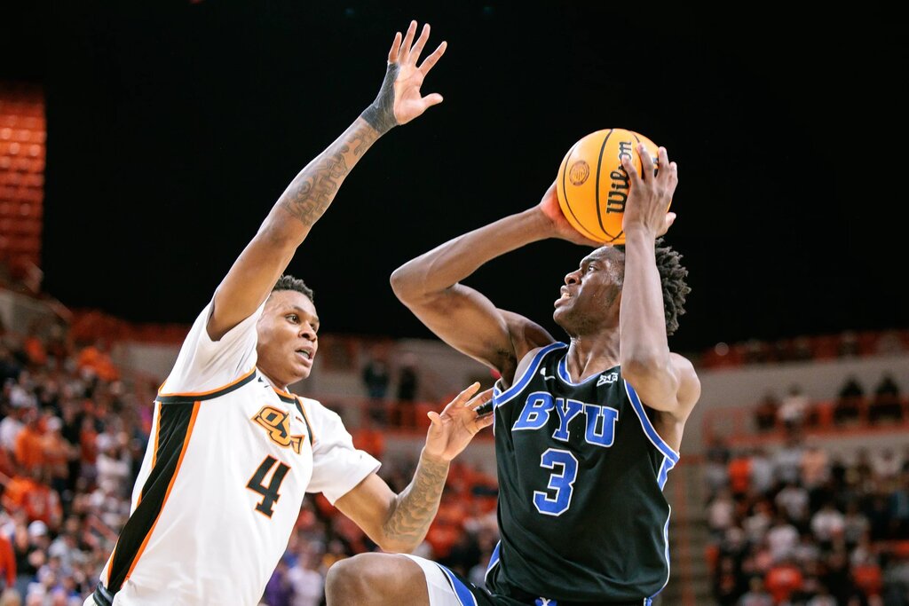 BYU Cougars forward AJ Dybantsa (3) drives around Oklahoma State Cowboys guard Christian Coleman (4) during the second half at Gallagher-Iba Arena.