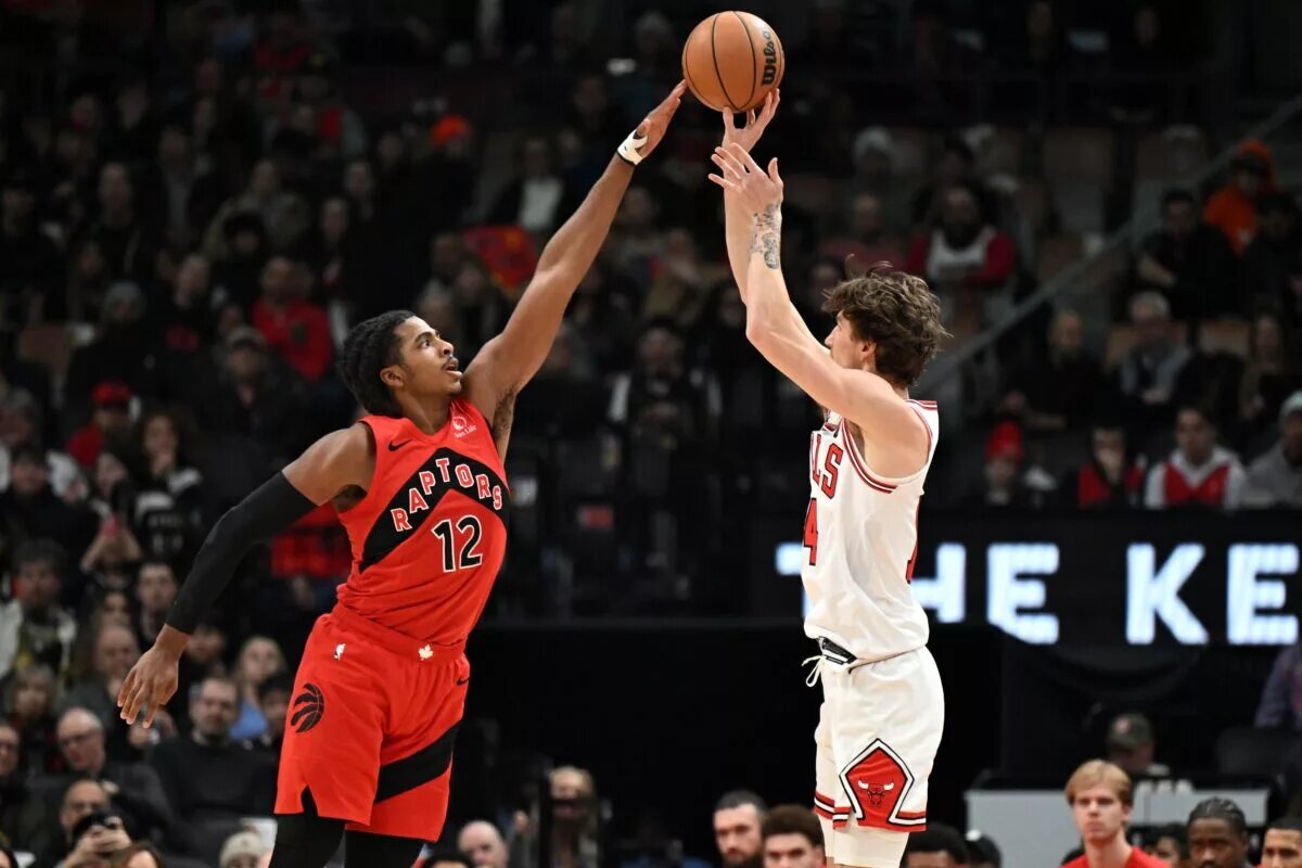 Feb 5, 2026; Toronto, Ontario, CAN; Toronto Raptors forward Collin Murray-Boyles (12) deflects a shot by Chicago Bulls forward Matas Buzelis (14) in the first half at Scotiabank Arena. Mandatory Credit: Dan Hamilton-Imagn Images