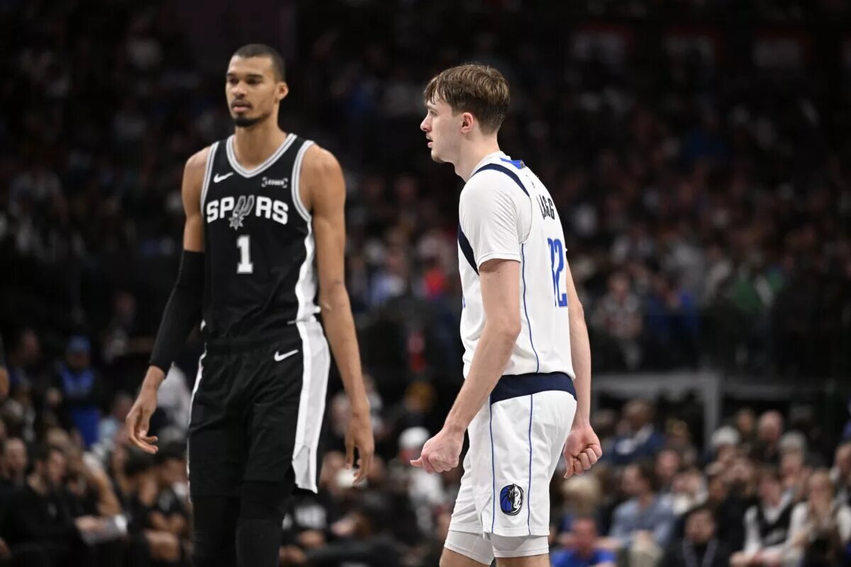 Feb 5, 2026; Dallas, Texas, USA; San Antonio Spurs forward Victor Wembanyama (1) walks past Dallas Mavericks forward Cooper Flagg (32) during the second half at the American Airlines Center. Mandatory Credit: Jerome Miron-Imagn Images