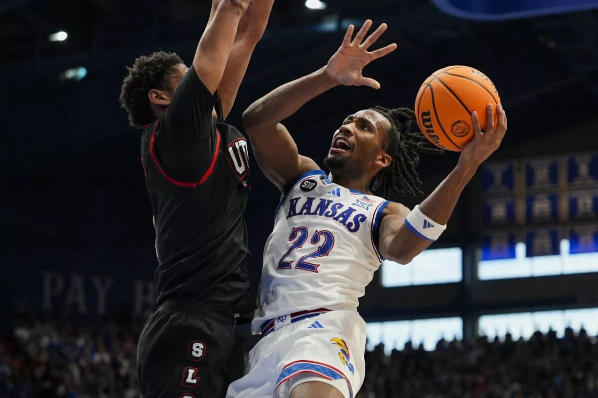 Kansas Jayhawks guard Darryn Peterson (22) shoots against Utah Utes forward Josh Hayes (7) during the second half at Allen Fieldhouse.