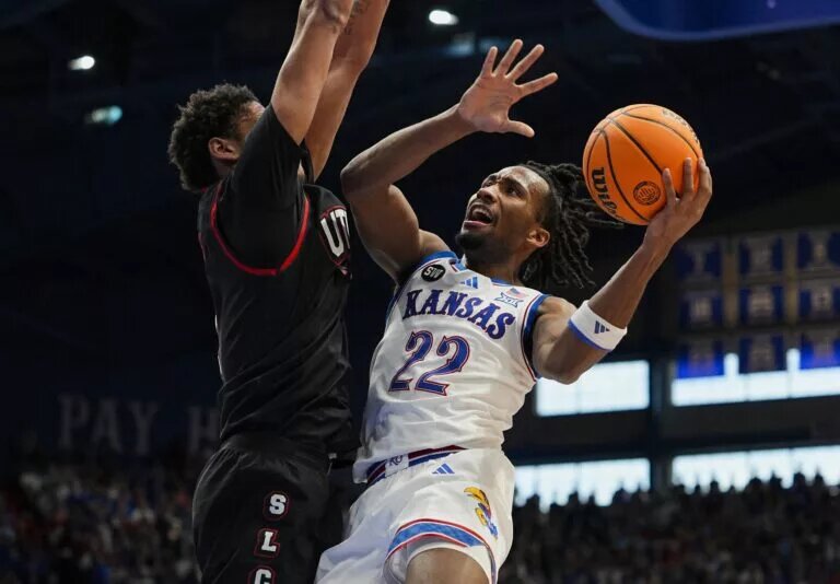 Kansas Jayhawks guard Darryn Peterson (22) shoots against Utah Utes forward Josh Hayes (7) during the second half at Allen Fieldhouse.