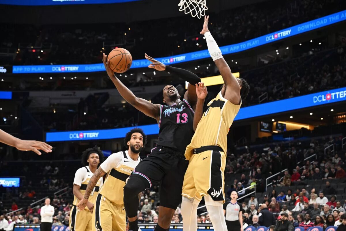 Feb 8, 2026; Washington, District of Columbia, USA; Miami Heat center Bam Adebayo (13) attempts a shot in front of Washington Wizards center Alex Sarr (20) during the first quarter at Capital One Arena. Mandatory Credit: Rafael Suanes-Imagn Images