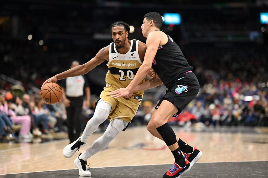 Washington Wizards center Alex Sarr (20) attempts to dribble past Miami Heat forward Simone Fontecchio (0) during the fourth quarter at Capital One Arena.