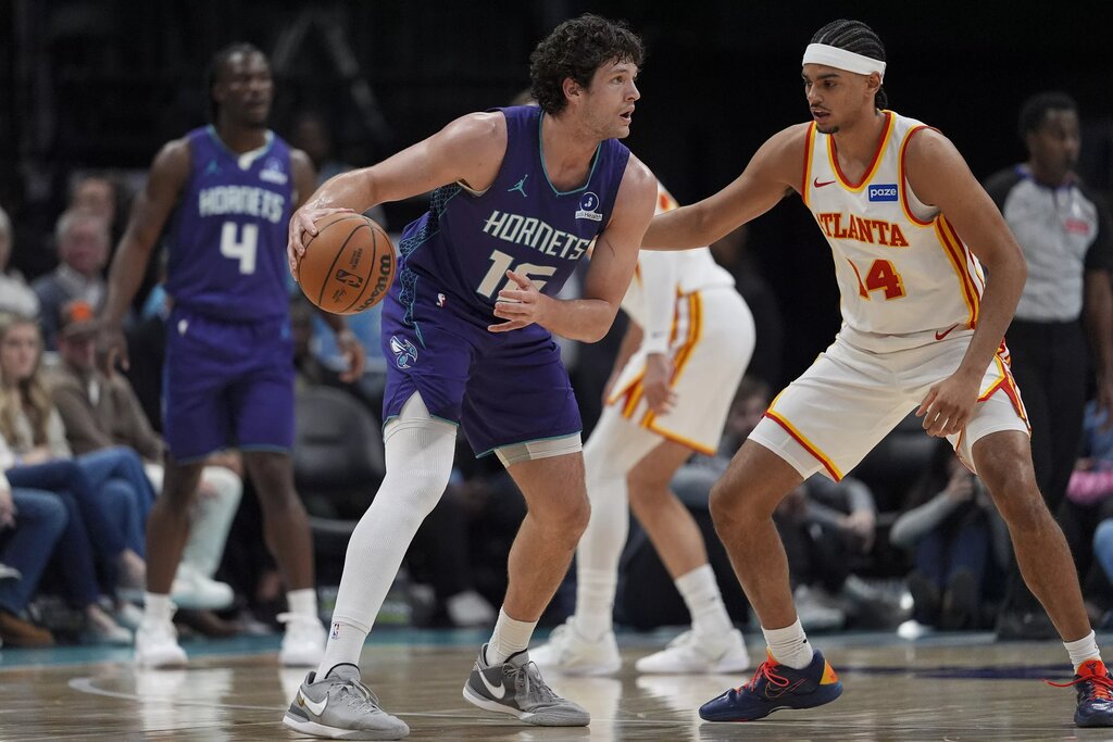 Feb 11, 2026; Charlotte, North Carolina, USA; Charlotte Hornets center PJ Hall (16) handles the ball against Atlanta Hawks forward Asa Newell (14) during first quarter at Spectrum Center. Mandatory Credit: Jim Dedmon-Imagn Images