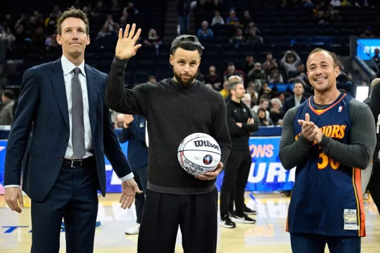 Feb 11, 2026; San Francisco, California, USA; Golden State Warriors guard Stephen Curry, center, accepts a ball honoring his All-Star Game selection from Golden State Warriors general manager Mike Dunleavy, left, and 12-year season ticket member Casey Kaminsky, right, before the game against the San Antonio Spurs at Chase Center. Mandatory Credit: Eakin Howard-Imagn Images