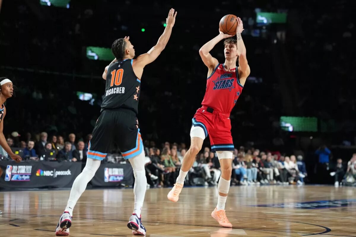 Team Vince frontcourt Matas Buzelis (14) of the Chicago Bulls shoots against Team T-Mac frontcourt Zaccharie Risacher (10) of the Atlanta Hawks during an NBA All Star Rising Stars game at Intuit Dome.