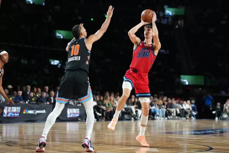 Team Vince frontcourt Matas Buzelis (14) of the Chicago Bulls shoots against Team T-Mac frontcourt Zaccharie Risacher (10) of the Atlanta Hawks during an NBA All Star Rising Stars game at Intuit Dome.
