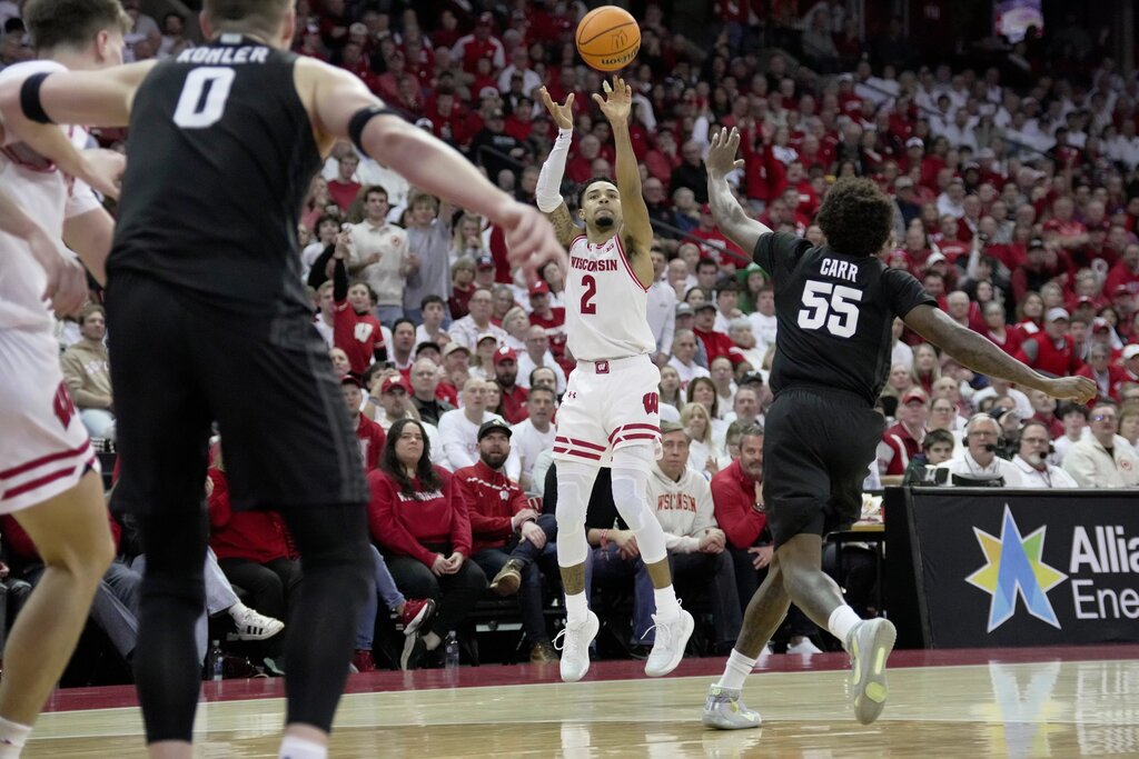 Wisconsin's Nick Boyd shoots a three over Michigan State's Coen Carr