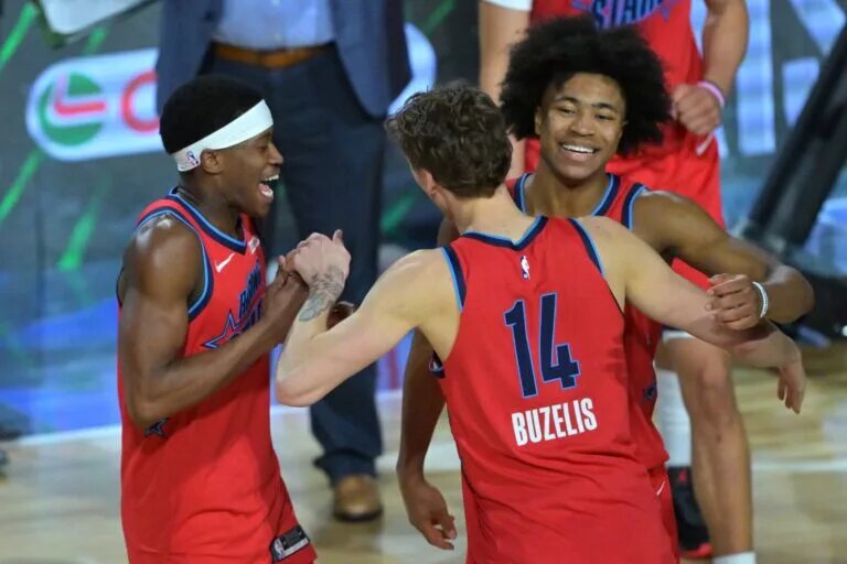Feb 13, 2026; Inglewood, California, USA; Team Vince guard VJ Edgecombe (77) of the Philadelphia 76ers and Matas Buzelis (14) of the Chicago Bulls and Jaylen Wells (0) of the Memphis Grizzlies react during an NBA All Star Rising Stars championship game at Intuit Dome. Mandatory Credit: Jayne Kamin-Oncea-Imagn Images