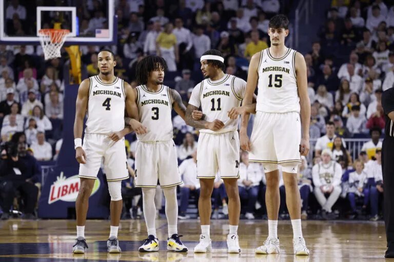 Michigan Basketball's Aday Mara (No. 15), and his teammates stand at center court