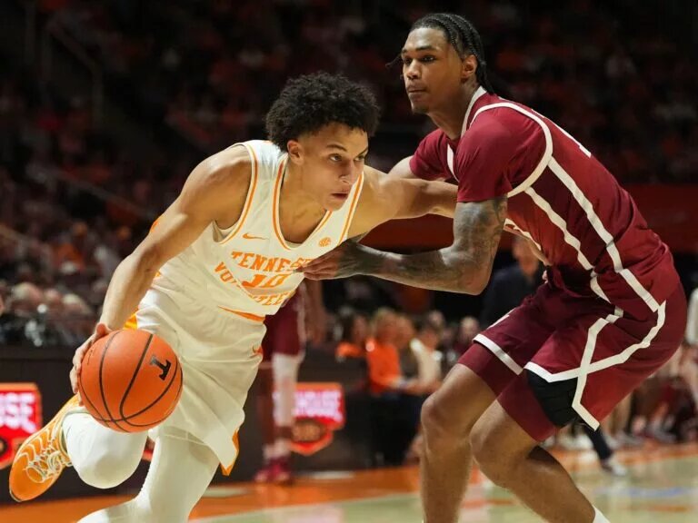 Tennessee forward Nate Ament (10) moves towards the basket while guarded by Oklahoma forward Tae Davis (13) in an NCAA college basketball game on Feb. 18, 2026, in Knoxville, Tennessee.