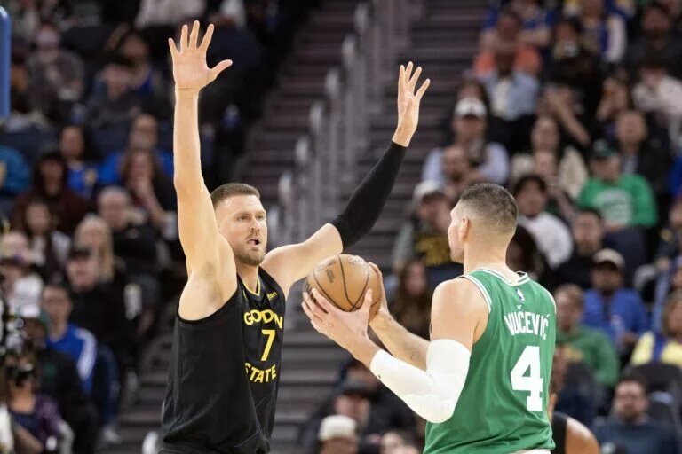 Feb 19, 2026; San Francisco, California, USA; Golden State Warriors center Kristaps Porzingis (7) guards Boston Celtics center Nikola Vucevic (4) during the third quarter at Chase Center. Mandatory Credit: D. Ross Cameron-Imagn Images