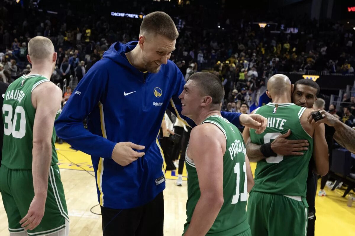 Golden State Warriors center Kristaps Porzingis reunites with former Boston Celtics teammate Payton Pritchard after the game