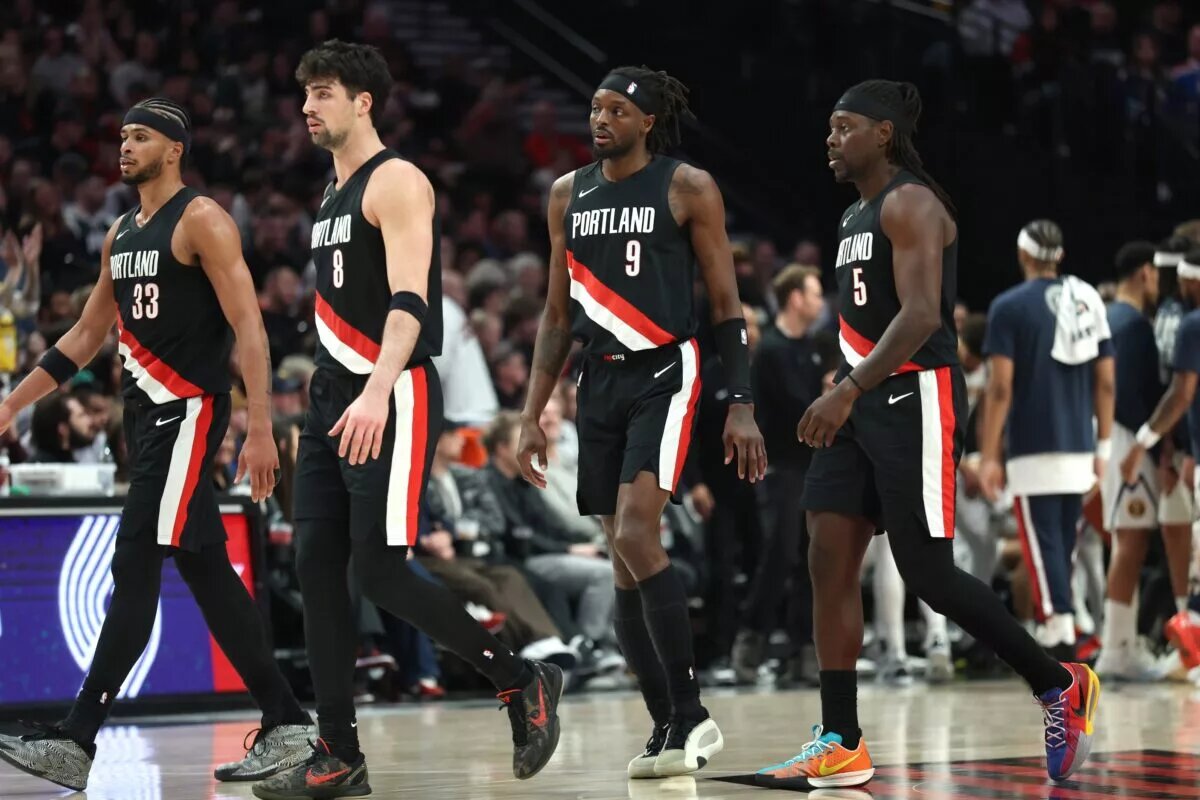 Feb 20, 2026; Portland, Oregon, USA; Portland Trail Blazers forward Toumani Camara (33), forward Deni Avdija (8), forward Jerami Grant (9) and guard Jrue Holiday (5) walk toward the bench in frustration during the second half against the Denver Nuggets at Moda Center. Mandatory Credit: Jaime Valdez-Imagn Images