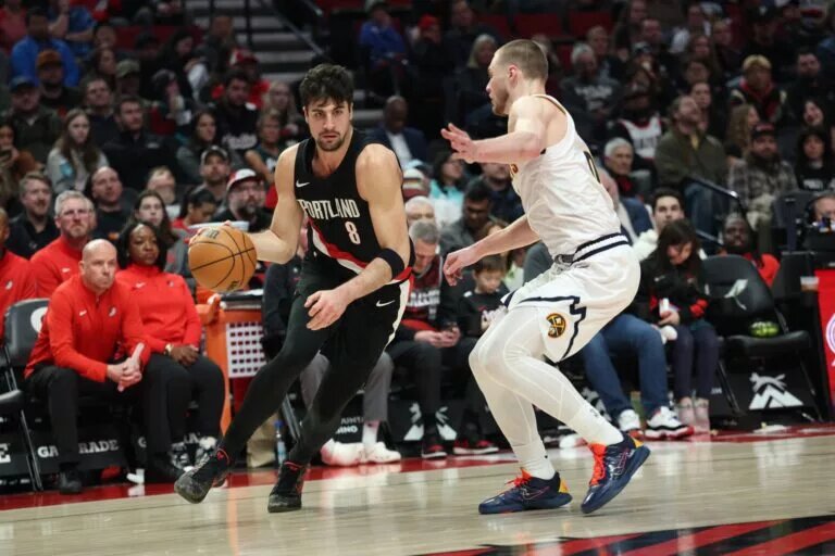 Portland Trail Blazers forward Deni Avdija (8) drives against Denver Nuggets guard Christian Braun (0) during the second half at Moda Center.