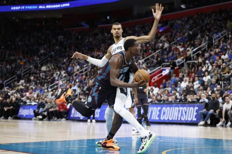 Feb 23, 2026; Detroit, Michigan, USA; Detroit Pistons center Jalen Duren (0) is defended by San Antonio Spurs forward Victor Wembanyama (1) in the second half at Little Caesars Arena. Mandatory Credit: Rick Osentoski-Imagn Images